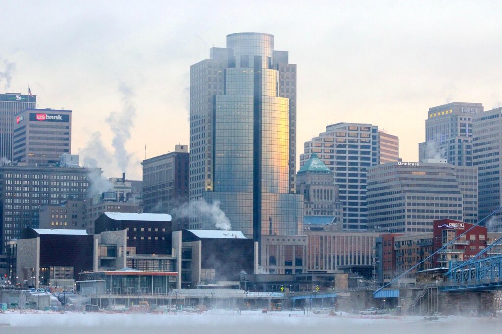 A winter view of skyscrapers, with steam coming off some of their roofs due to the cold